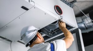 ventilation and cooling hvac engineer installing heat recovery unit